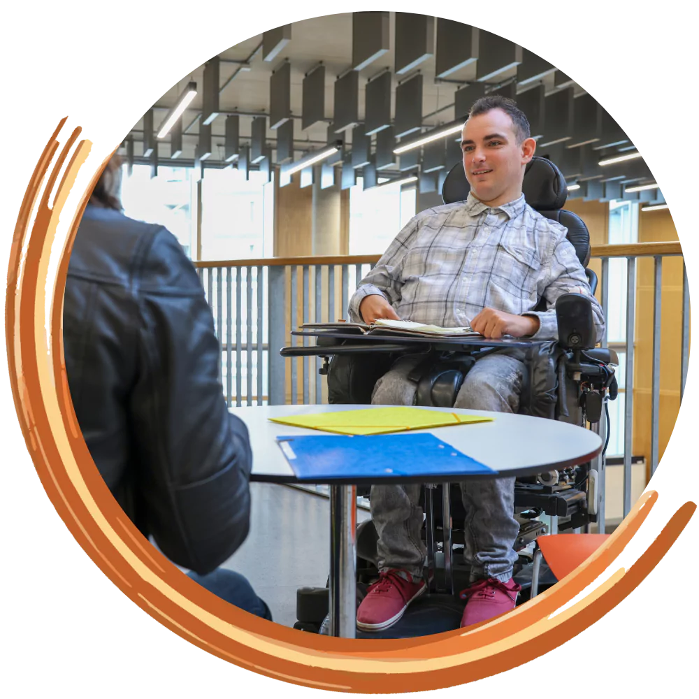 Disabled man in wheelchair smiling with friend